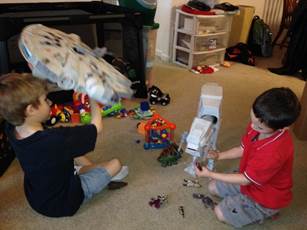 A couple of kids playing with toys
Description automatically generated with low confidence